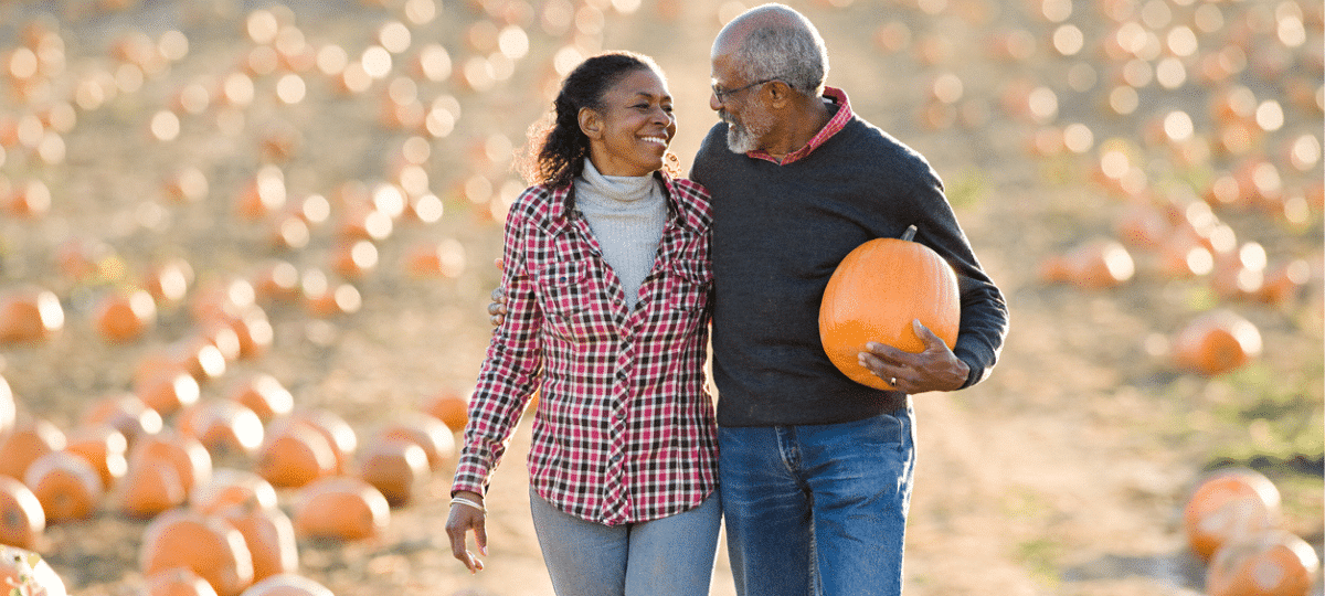 Couple walking in pumpkin patch